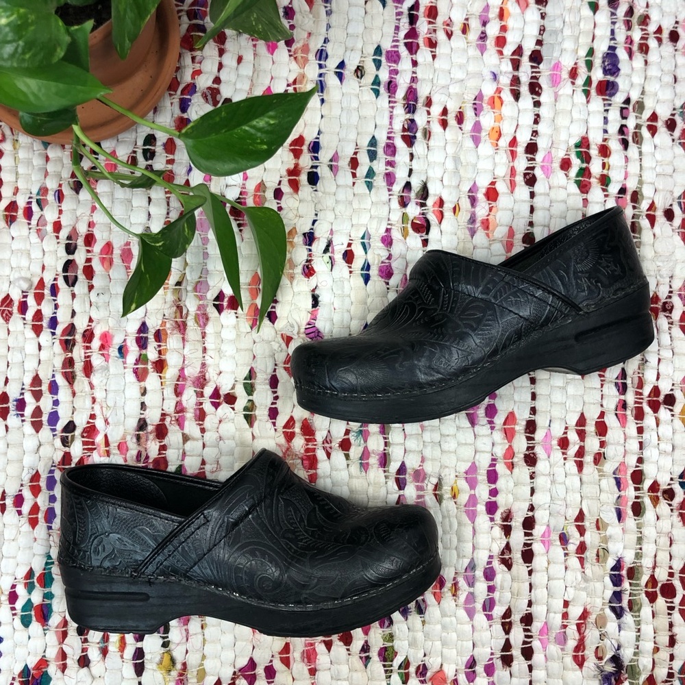 Dansko Black Floral Embossed Leather Stapled Clogs